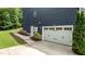 Attached two car garage with a well manicured lawn on a sunny day at 8304 Southmoor Hill Trl, Wake Forest, NC 27587