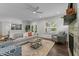 Bright and airy living room featuring comfortable seating, a modern fireplace, and ample natural light at 8304 Southmoor Hill Trl, Wake Forest, NC 27587