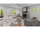 Cozy living room featuring a fireplace with stone accents, comfortable seating, and natural light at 8304 Southmoor Hill Trl, Wake Forest, NC 27587