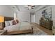 Comfortable main bedroom with tray ceiling, ceiling fan, and wood-look floors at 8304 Southmoor Hill Trl, Wake Forest, NC 27587
