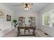 Bright office space featuring a desk, bookshelves, a ceiling fan, and a window with natural light at 8304 Southmoor Hill Trl, Wake Forest, NC 27587