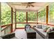 Relaxing screened porch with comfortable wicker furniture and views of the surrounding trees at 8304 Southmoor Hill Trl, Wake Forest, NC 27587
