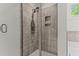 Clean shower stall with gray tile and glass door at 8304 Southmoor Hill Trl, Wake Forest, NC 27587