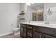 Bathroom features double vanity, floating shelves and glass shower at 9327 Falkwood Rd, Raleigh, NC 27617