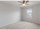 Bright bedroom featuring plush carpet, a ceiling fan, and a window that brings in natural light at 9327 Falkwood Rd, Raleigh, NC 27617