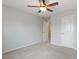 Neutral bedroom featuring a ceiling fan and carpet, with doorway and closet doors visible at 9327 Falkwood Rd, Raleigh, NC 27617