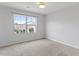 Clean bedroom featuring a large window bringing in natural light and carpeted flooring at 9327 Falkwood Rd, Raleigh, NC 27617
