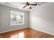 Bright bedroom features a window, ceiling fan, and neutral carpet at 9327 Falkwood Rd, Raleigh, NC 27617