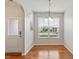 Bright dining area with hardwood floors, chandelier lighting, and large window at 9327 Falkwood Rd, Raleigh, NC 27617