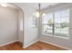 Bright dining area with hardwood floors, chandelier lighting, and large window at 9327 Falkwood Rd, Raleigh, NC 27617