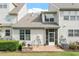 Back exterior of house with patio, screened-in porch, and greenery with a blue sky at 9327 Falkwood Rd, Raleigh, NC 27617