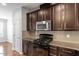 Gourmet kitchen showcasing granite countertops and stainless steel appliances at 9327 Falkwood Rd, Raleigh, NC 27617