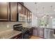 Well-equipped kitchen with granite countertops, and modern stainless steel appliances at 9327 Falkwood Rd, Raleigh, NC 27617