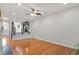 Open concept living room with hardwood floors and a view to the adjacent kitchen at 9327 Falkwood Rd, Raleigh, NC 27617