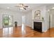 Open living room featuring fireplace, wood floors, and sliding door access to the backyard at 9327 Falkwood Rd, Raleigh, NC 27617