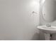 Cozy powder room features a pedestal sink and modern fixtures at 9327 Falkwood Rd, Raleigh, NC 27617