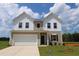 Charming two-story home with a white garage, neutral siding, and a well-manicured lawn at 935 Bombardier Ln, Spring Hope, NC 27882