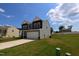 Beautiful, two-story home with a manicured lawn and a spacious driveway and two-car garage at 956 Bombardier Ln, Spring Hope, NC 27882