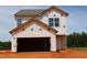 New construction home showing the framing stage, garage, and front entrance at 959 Bombardier Aly, Spring Hope, NC 27882