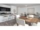 Open living space includes a modern kitchen with bar seating and a dining area at 959 Bombardier Aly, Spring Hope, NC 27882