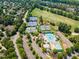 An aerial view featuring tennis courts, a swimming pool, and green space, all within a beautiful residential community at 9603 Clubvalley Way, Raleigh, NC 27617