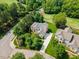 Aerial view showcasing a beautiful home with a well-manicured lawn and mature trees at 9603 Clubvalley Way, Raleigh, NC 27617