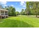 Expansive backyard with a well-manicured lawn and mature trees at 9603 Clubvalley Way, Raleigh, NC 27617