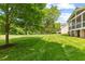Beautiful backyard with lush green grass and mature trees at 9603 Clubvalley Way, Raleigh, NC 27617