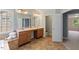 Bright bathroom features a double vanity with granite countertop and ceramic tile flooring at 9603 Clubvalley Way, Raleigh, NC 27617