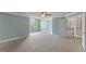 Large bedroom with plush carpeting, ceiling fan, and a staircase entrance at 9603 Clubvalley Way, Raleigh, NC 27617
