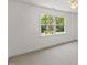 Bright, carpeted bedroom with large window offering natural light and views of greenery at 9603 Clubvalley Way, Raleigh, NC 27617