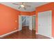 Bright bedroom with hardwood floors, ceiling fan, and multiple doorways, providing ample space at 9603 Clubvalley Way, Raleigh, NC 27617