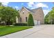 Exterior view of a brick home with a long driveway leading to a two-car garage, surrounded by greenery at 9603 Clubvalley Way, Raleigh, NC 27617