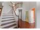 Spacious entryway with staircase, hardwood floors, and adjacent rooms, creating a welcoming entrance at 9603 Clubvalley Way, Raleigh, NC 27617