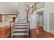 Grand foyer with hardwood floors, a staircase with white spindles, and views into adjoining living spaces at 9603 Clubvalley Way, Raleigh, NC 27617