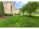 Lush front yard showcasing beautiful landscaping and mature trees surrounding an elegant brick home at 9603 Clubvalley Way, Raleigh, NC 27617