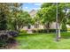 Spacious front yard featuring a well-manicured lawn and mature trees surrounding a beautiful brick home at 9603 Clubvalley Way, Raleigh, NC 27617