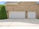 Spacious three-car garage with white doors and ample driveway parking at 9603 Clubvalley Way, Raleigh, NC 27617