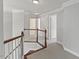 Bright hallway with white trim and neutral carpet leads to bedrooms at 9603 Clubvalley Way, Raleigh, NC 27617