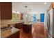 A modern kitchen boasts cherry cabinets, granite countertops, stainless appliances, and opens to the Gathering room at 9603 Clubvalley Way, Raleigh, NC 27617