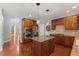 Kitchen with stainless steel appliances, granite countertops, cherry cabinets, and island at 9603 Clubvalley Way, Raleigh, NC 27617