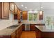 Kitchen featuring cherry cabinets, granite countertops, stainless steel appliances, and an island at 9603 Clubvalley Way, Raleigh, NC 27617