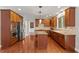 A modern kitchen with stainless steel appliances, granite countertops, cherry cabinets, and a center island at 9603 Clubvalley Way, Raleigh, NC 27617