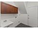 Functional laundry room with cabinets, sink, and white door, offering convenience at 9603 Clubvalley Way, Raleigh, NC 27617