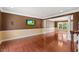 Spacious living room with hardwood floors, elegant columns, and a view of a chandelier and natural light at 9603 Clubvalley Way, Raleigh, NC 27617