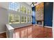 Spacious living room with a stone fireplace, hardwood floors, and large windows with a view at 9603 Clubvalley Way, Raleigh, NC 27617