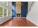 Bright living room with a stone fireplace and large windows, showcasing a cozy and inviting space at 9603 Clubvalley Way, Raleigh, NC 27617
