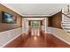 Expansive living room with hardwood floors, featuring columns, a chandelier, and large windows for natural light at 9603 Clubvalley Way, Raleigh, NC 27617