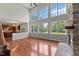 Spacious living room featuring a stone fireplace, large windows, and an open view to the kitchen at 9603 Clubvalley Way, Raleigh, NC 27617
