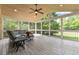 Bright sunroom with a vaulted ceiling, ceiling fan, and a view of the backyard at 9603 Clubvalley Way, Raleigh, NC 27617